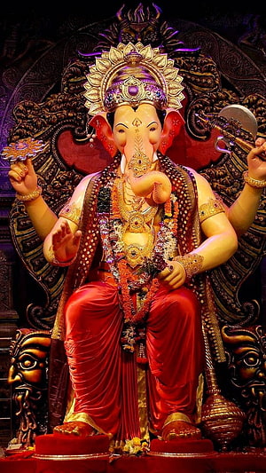 Lalbagcha Raja Ganesh Murti in Ornate Temple Setting with Red Drape and Gold Crown HD phone wallpaper