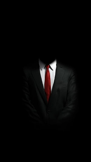 Mysterious Faceless Man in Black Suit with Red Tie Against Dark Background HD phone wallpaper