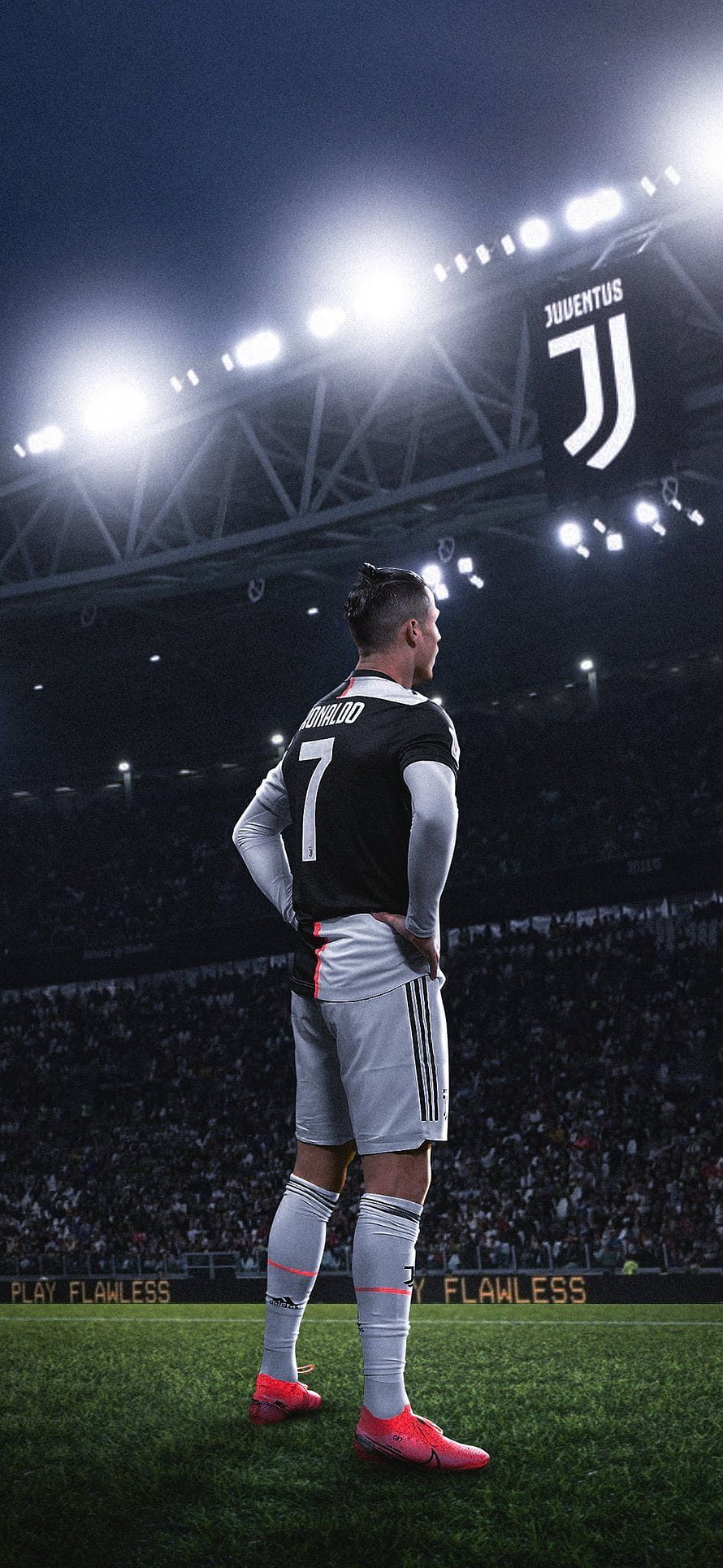 Cristiano Ronaldo in Juventus Kit Standing on the Pitch Under Stadium Lights HD phone wallpaper