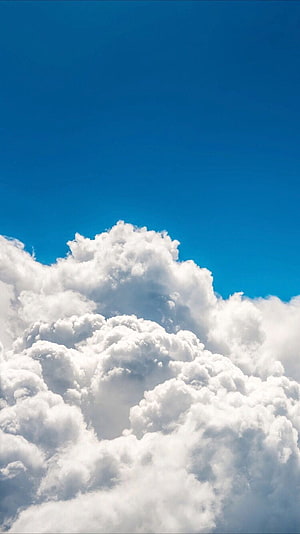 Fluffy Cumulus Clouds Against a Deep Blue Sky HD phone wallpaper