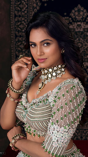 Ramya Pandian in an ornate green and pink embroidered lehenga with traditional Indian jewelry HD phone wallpaper