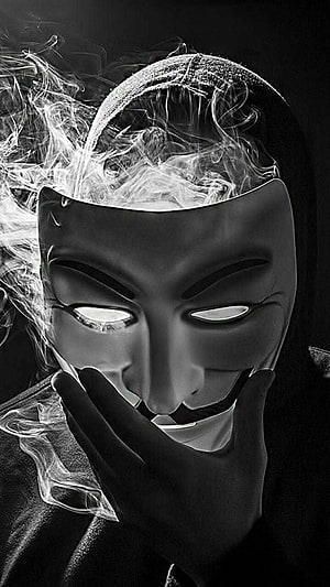 Black and White Guy Fawkes Mask Portrait with Dramatic Smoke and Hooded Figure HD phone wallpaper