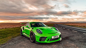 Vibrant Green Porsche 911 GT3 RS Parked on a Scenic Country Road at Sunset HD wallpaper