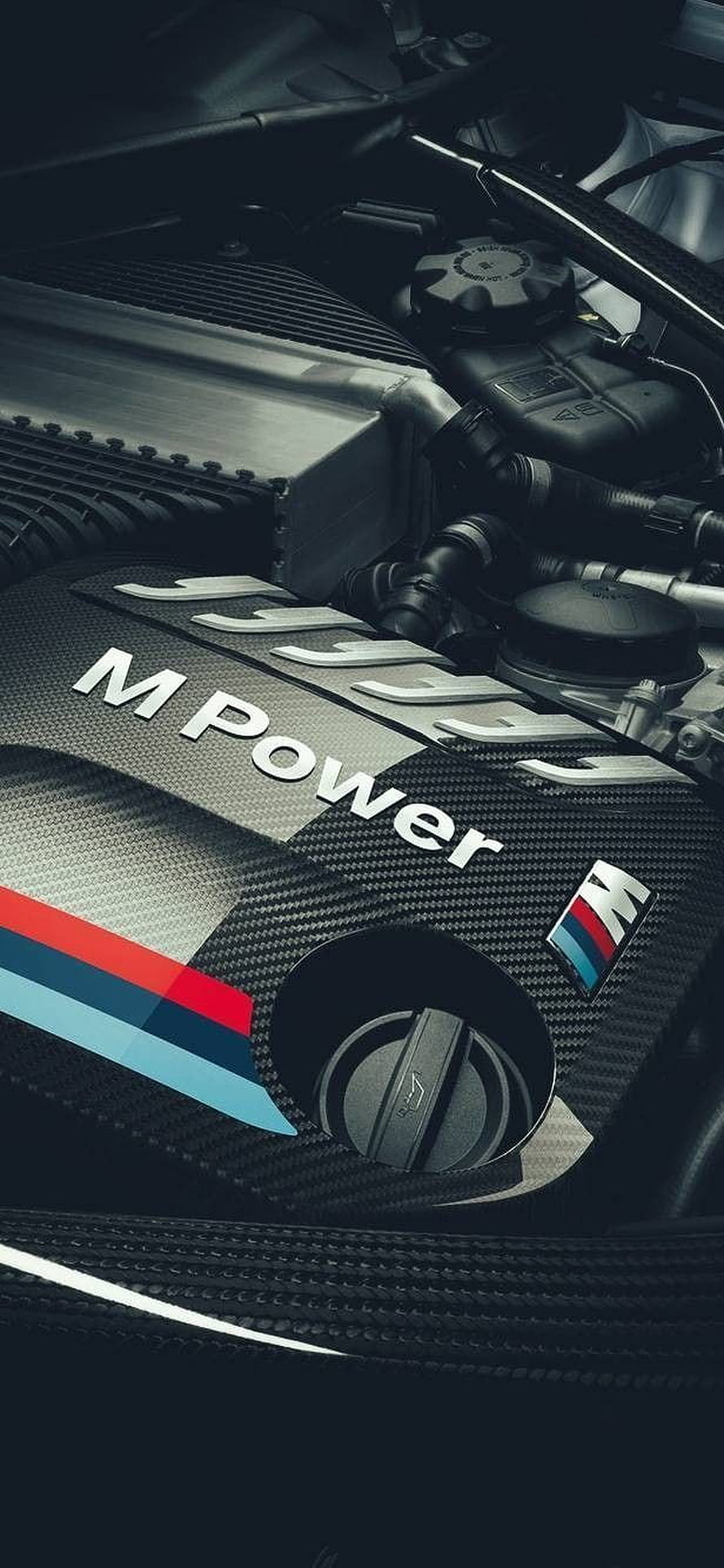 BMW M Power Engine Bay Close-Up with Carbon Fiber Cover and Signature Stripes HD phone wallpaper