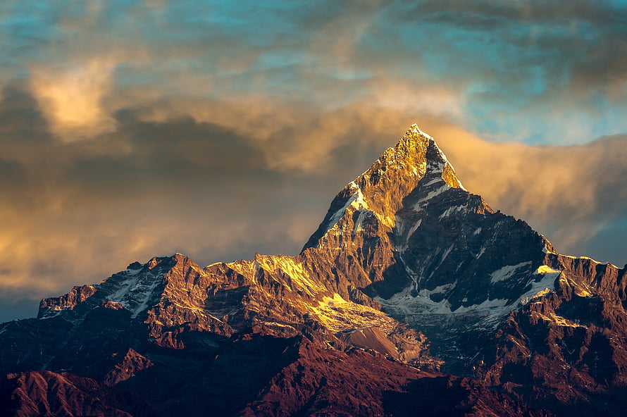 Annapurna Peak in the Himalayas at Golden Hour with Dramatic Clouds HD wallpaper
