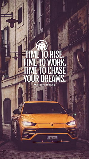 Orange Lamborghini Urus on European Street with Motivational Quote Overlay HD phone wallpaper