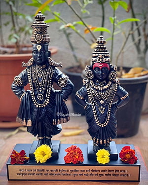 Vithu Mauli Couple Statues with Marathi Inscription and Marigold Flowers HD phone wallpaper