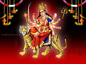 Goddess Durga Riding a Tiger with Multiple Arms and Divine Weapons HD wallpaper