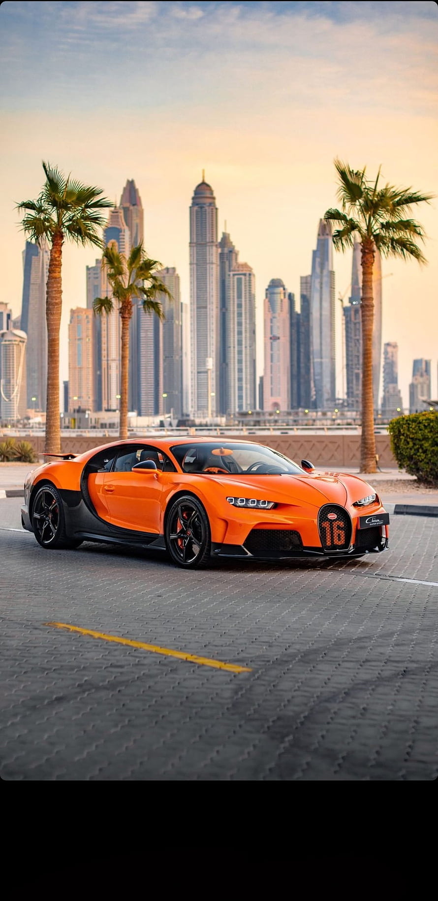 Orange Bugatti Chiron Super Sport Parked in Dubai with Palm Trees and Skyscrapers at Sunset HD phone wallpaper