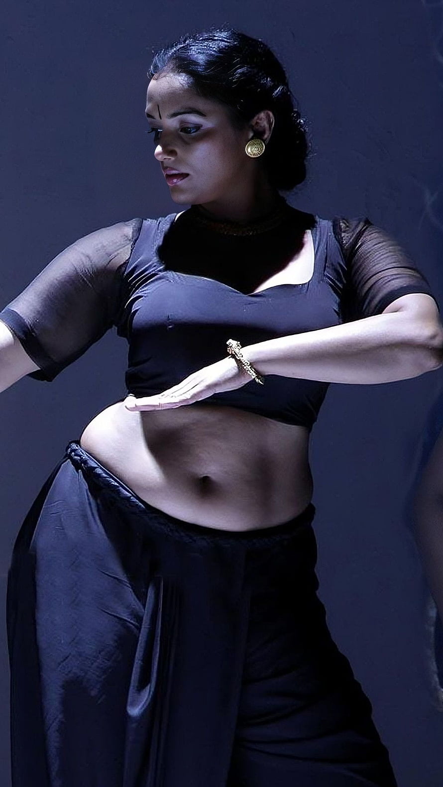 Swetha Menon in a dramatic black dance costume with expressive hand gestures HD phone wallpaper