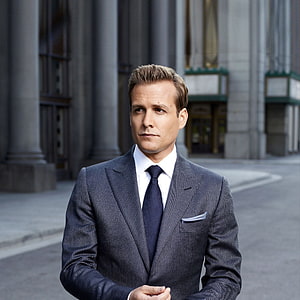 Harvey Specter in a pinstripe suit standing before a grand stone building HD phone wallpaper