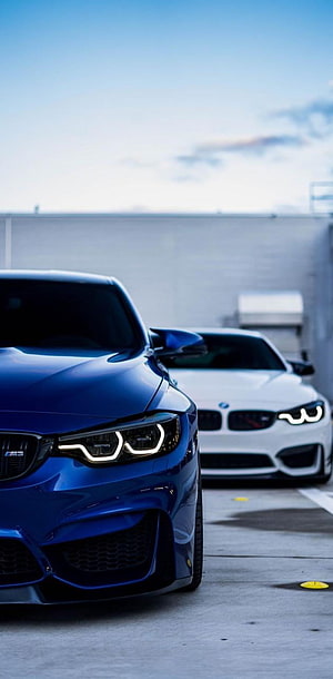 Blue BMW M4 CS and White M4 Parked Side by Side in a Concrete Lot HD phone wallpaper