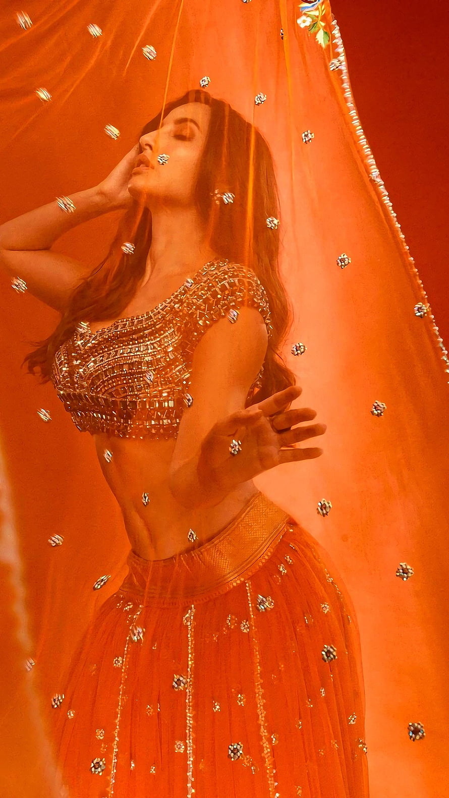 Nora Fatehi in an ornate orange lehenga with sheer embellished dupatta HD phone wallpaper