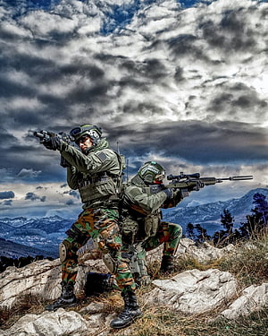 Two Special Forces Soldiers in Camouflage Taking Aim on a Rocky Mountain Ridge HD phone wallpaper