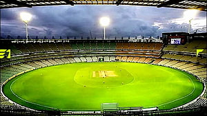 Vibrant Cricket Stadium Under Dramatic Stormy Sky With Floodlights HD wallpaper