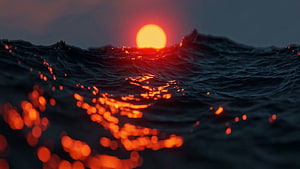 Dramatic Ocean Sunset with Glowing Red Sun and Dark Churning Waves HD wallpaper