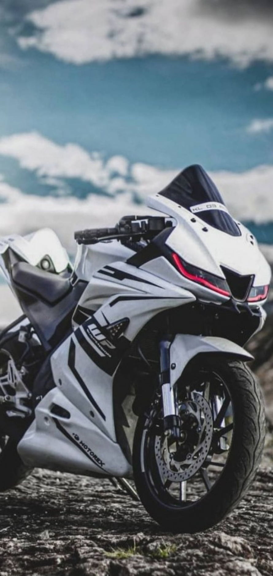 White MotoRex KL-09 Sport Motorcycle Parked on Rocky Terrain Under Blue Sky HD phone wallpaper