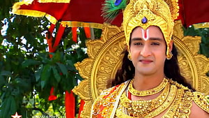 Krishna in ornate golden crown and jewelry with peacock feather and red ceremonial canopy HD wallpaper