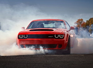 Red Dodge Challenger SRT Demon Performing a Burnout on Asphalt HD wallpaper