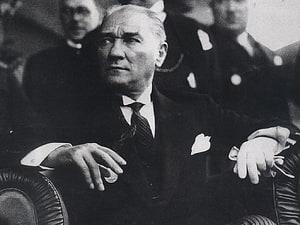 Mustafa Kemal Ataturk in Formal Attire Seated in a Classic Black and White Portrait HD wallpaper