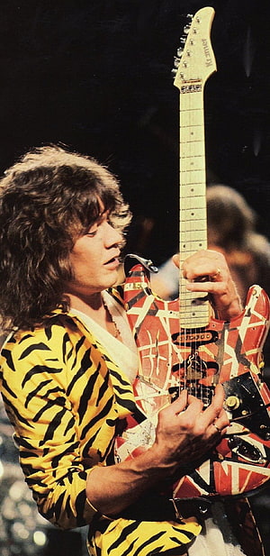 Eddie Van Halen performing live in a tiger print shirt with his iconic Frankenstein guitar HD phone wallpaper