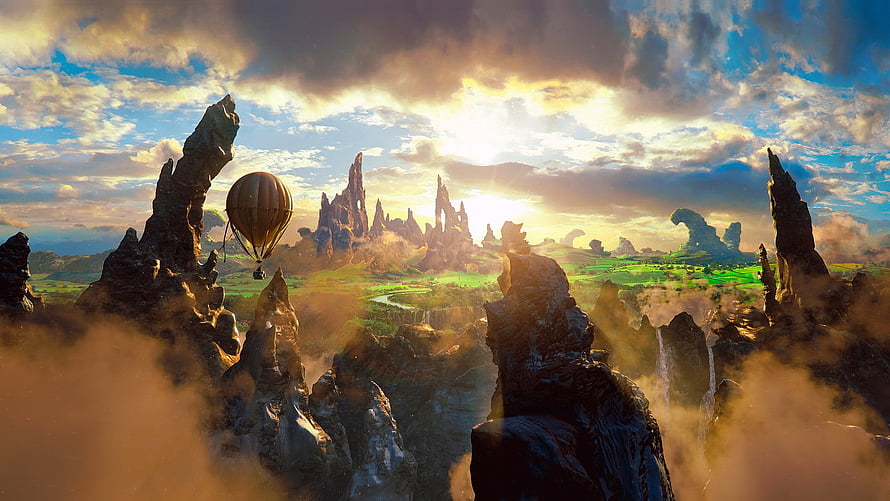 Hot Air Balloon Drifting Over Dramatic Fantasy Mountain Peaks at Golden Hour HD wallpaper