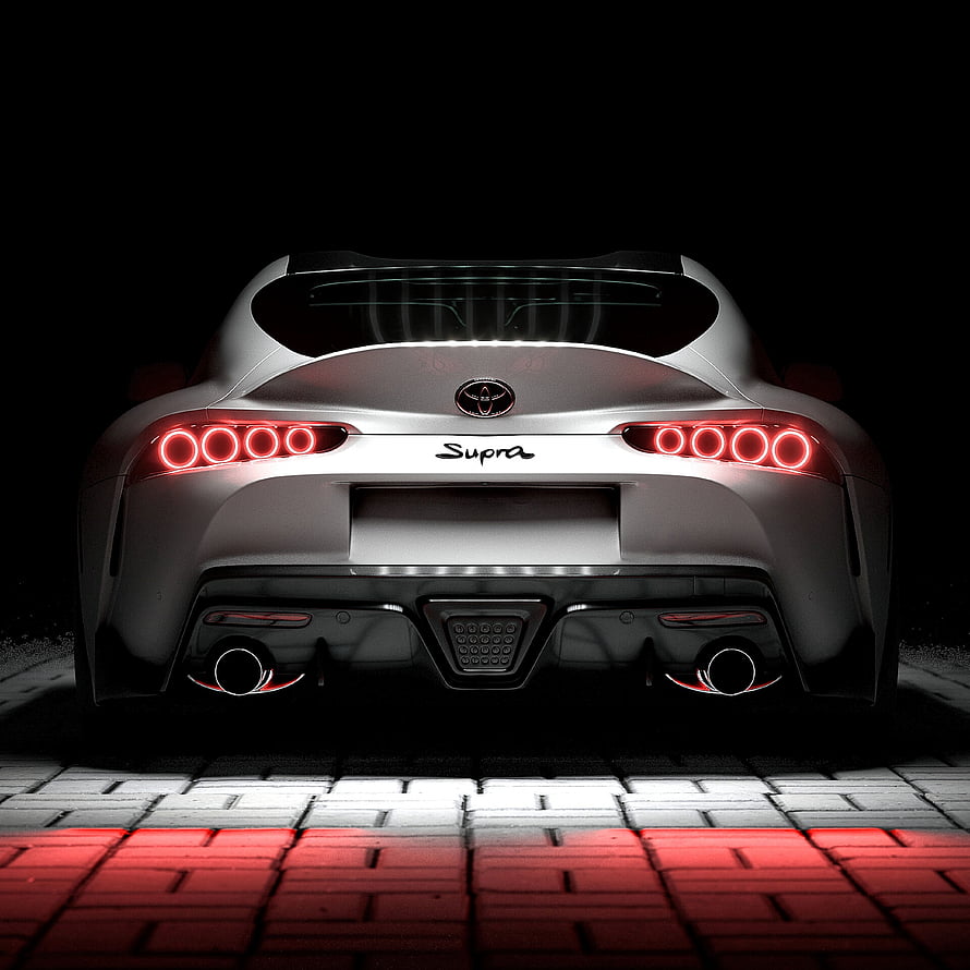 Rear View of a Silver Toyota Supra with Glowing Red Taillights on a Brick Surface HD phone wallpaper