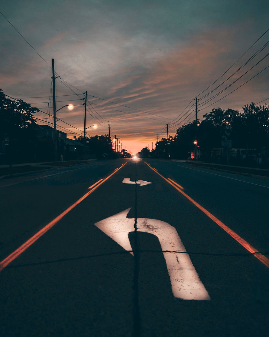 Empty City Road at Dusk with Directional Arrows and Power Lines HD phone wallpaper