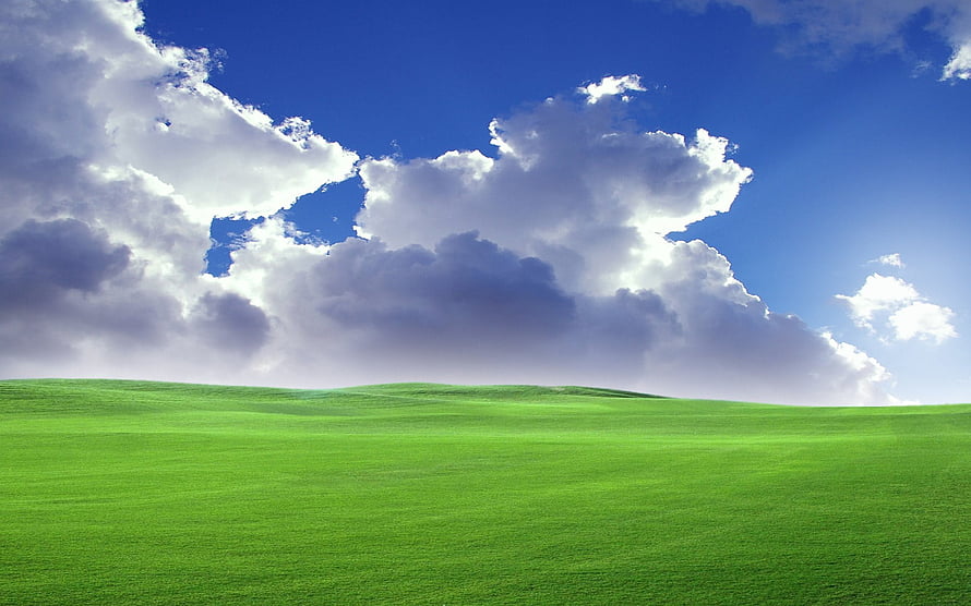 Vast Green Rolling Hills Under a Bright Blue Sky with Dramatic White Clouds HD wallpaper