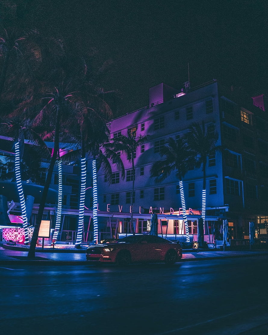 Neon-lit Vice City street scene with palm trees and a parked car at night HD phone wallpaper
