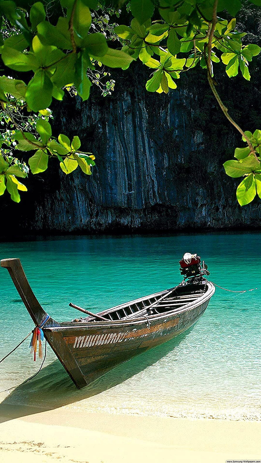 Traditional Longtail Boat Moored on Turquoise Water Near Lush Tropical Foliage HD phone wallpaper