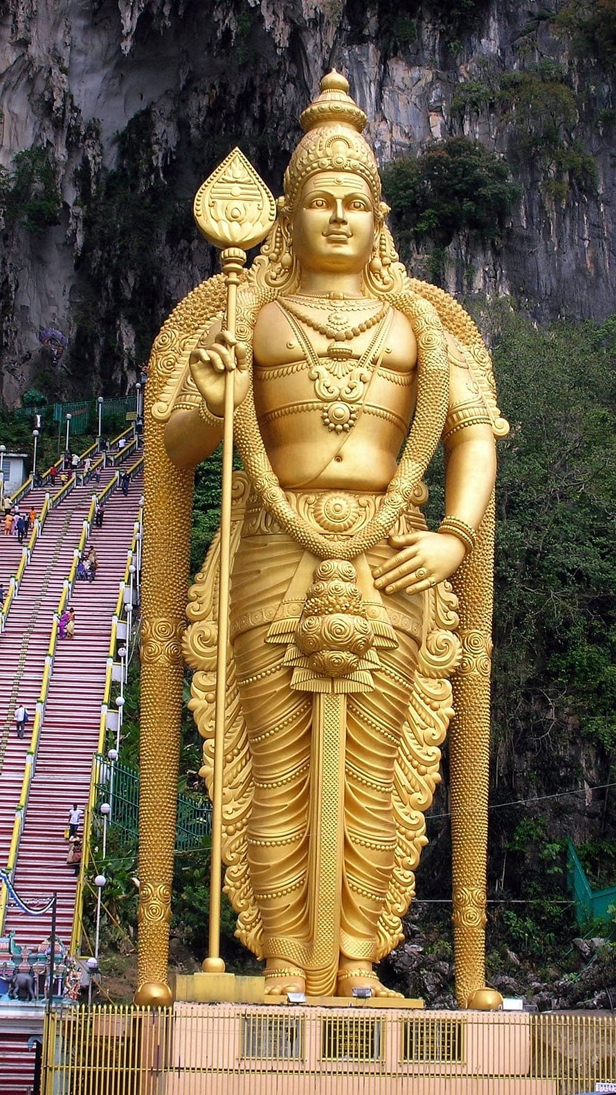 Giant Golden Murugan Statue at Batu Caves with Long Staircase and Limestone Cliffs HD phone wallpaper