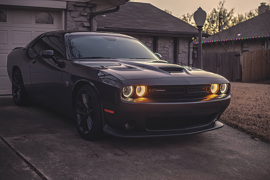 Black Dodge Challenger SRT Hellcat Parked in a Residential Driveway at Dusk HD wallpaper