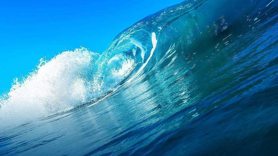 Dramatic Curling Ocean Wave with Turquoise Water and White Foam Against a Clear Blue Sky HD wallpaper