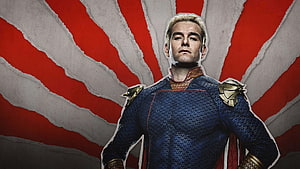 Homelander from The Boys in blue tactical suit with gold shoulder armor against red and white radial background HD wallpaper