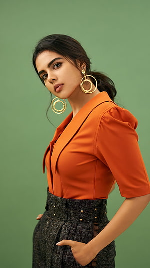 Kalyani Priyadarshini in Orange Blouse and Textured Trousers with Gold Hoop Earrings HD phone wallpaper