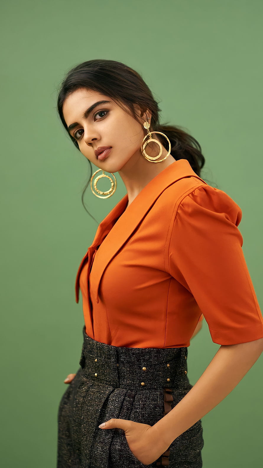Kalyani Priyadarshini in Orange Blouse and Textured Trousers with Gold Hoop Earrings HD phone wallpaper