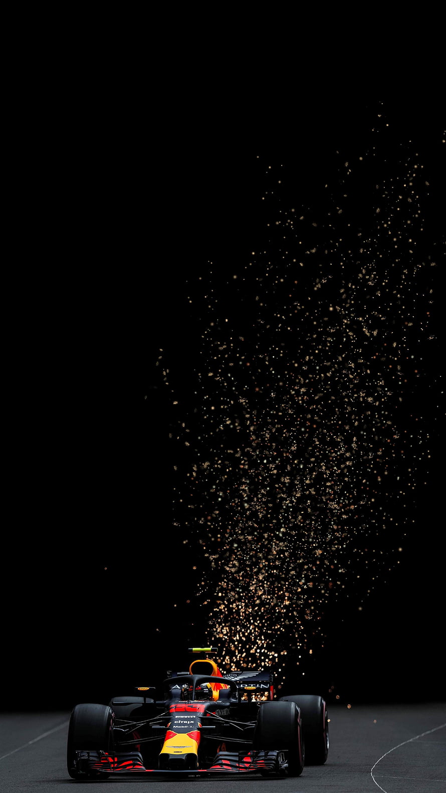 Red Bull Racing Formula 1 car emitting sparks on a dark track at night HD phone wallpaper