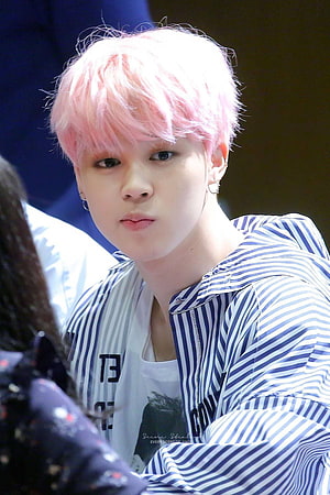 Jimin from BTS with pastel pink hair wearing a blue and white striped jacket HD phone wallpaper