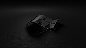 Sleek Black Windows 10 Logo Emblem on Dark Textured Surface HD wallpaper