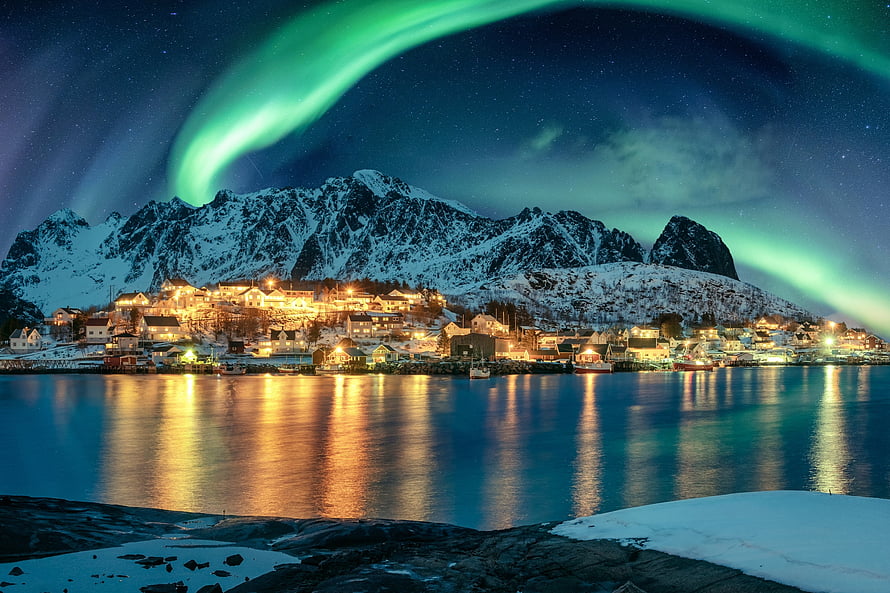 Aurora Borealis over a Snowy Norwegian Coastal Village at Night HD wallpaper