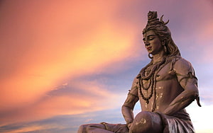 Lord Shiva Statue Silhouette Against Vibrant Sunset Sky HD wallpaper