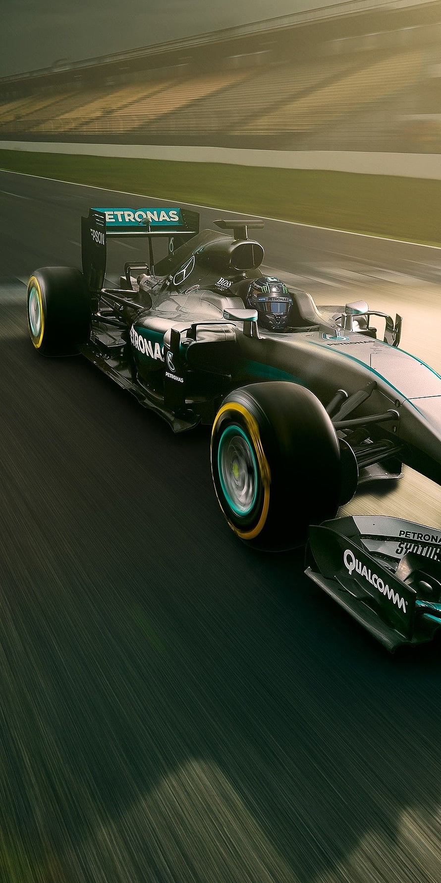 Mercedes-AMG Petronas Formula 1 car speeding on a racetrack with motion blur and teal livery HD phone wallpaper