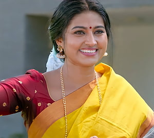 Sneha in a vibrant yellow and maroon traditional sari with gold jewelry HD wallpaper