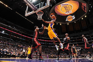 Kobe Bryant dunking over a defender during a Los Angeles Lakers NBA game HD wallpaper
