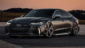 Audi RS7 Sportback with custom contour wrap and aggressive front bumper at sunset HD wallpaper