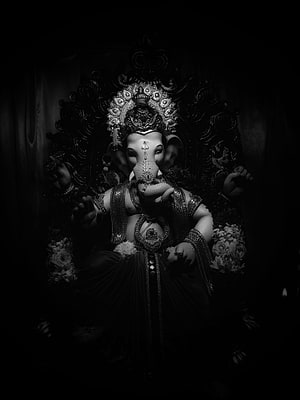 Dramatic Black and White Portrait of Lord Ganesha with Ornate Crown and Floral Decorations HD phone wallpaper