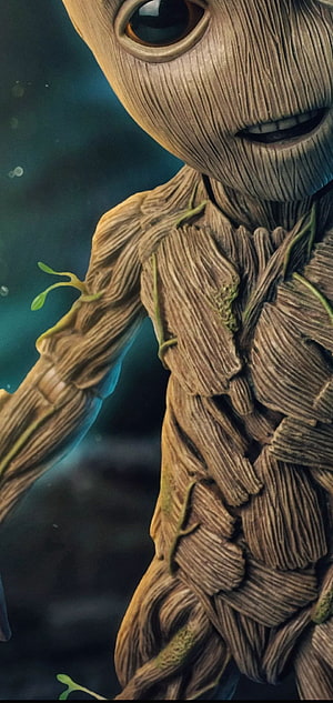 Baby Groot Close-Up Portrait with Wood Grain Texture and Green Sprouts HD phone wallpaper