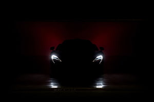 McLaren P1 Supercar Silhouette with Glowing Headlights in Dark Red Atmosphere HD wallpaper