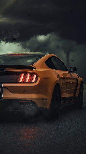 Orange Ford Mustang GT Rear View Under Dark Stormy Sky With Exhaust Smoke HD phone wallpaper